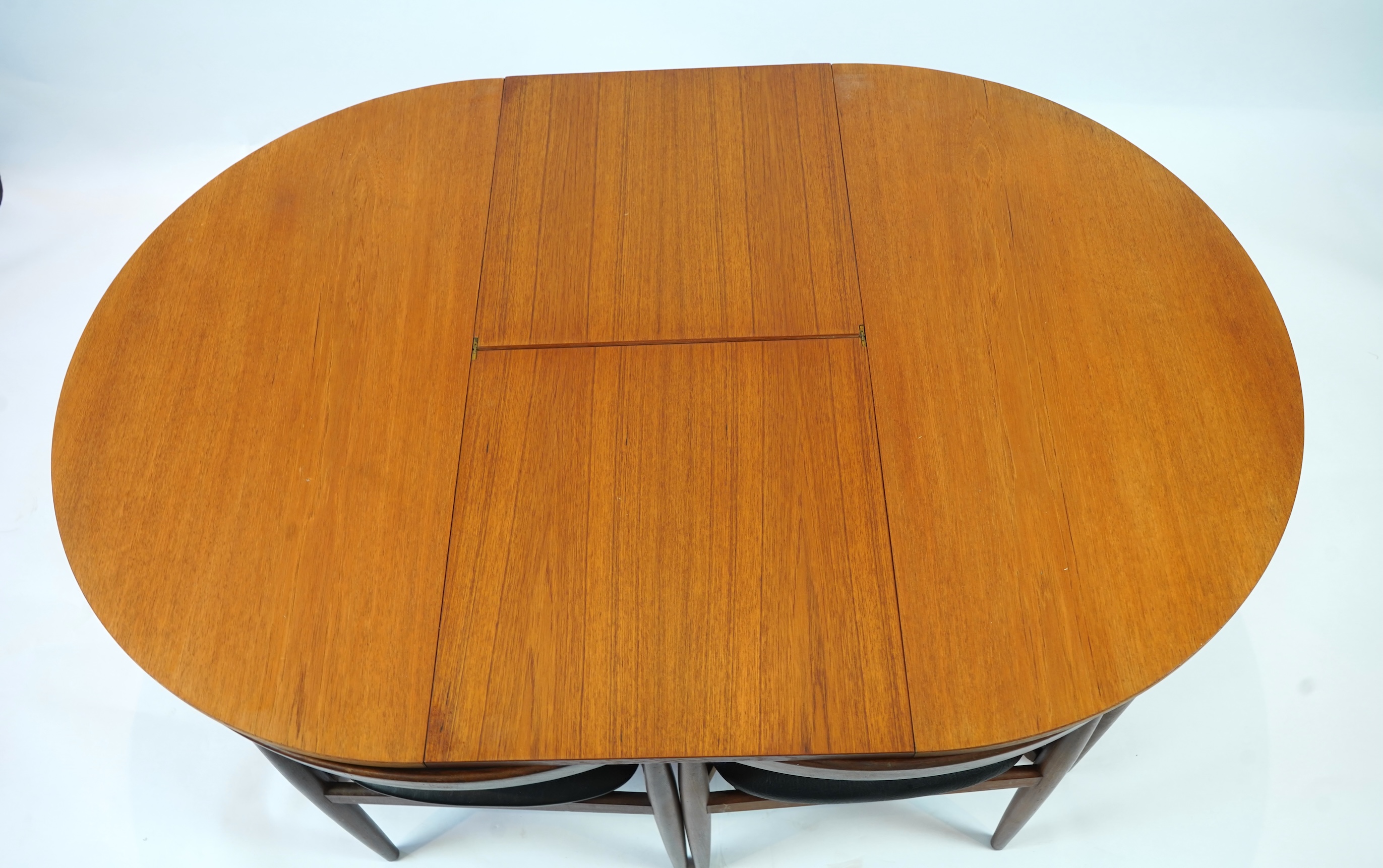 Hans Olsen (Danish, 1919–1992) for Frem Røjle: A Danish teak 'Roundette' extending dining table and six chairs